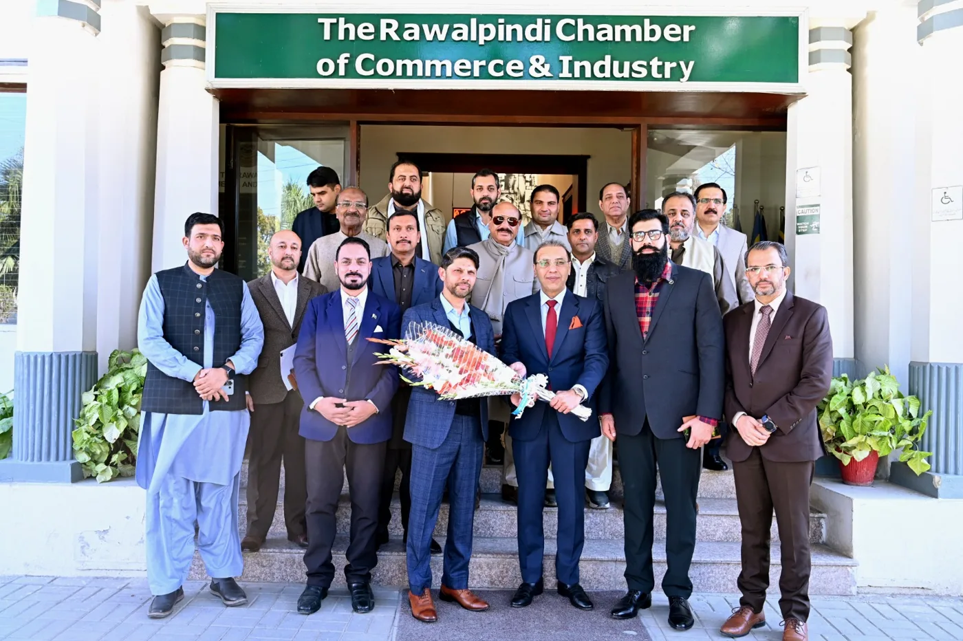 The Rawalpindi Chamber of Commerce and Industry delegation group photo on the steps of the Chamber building